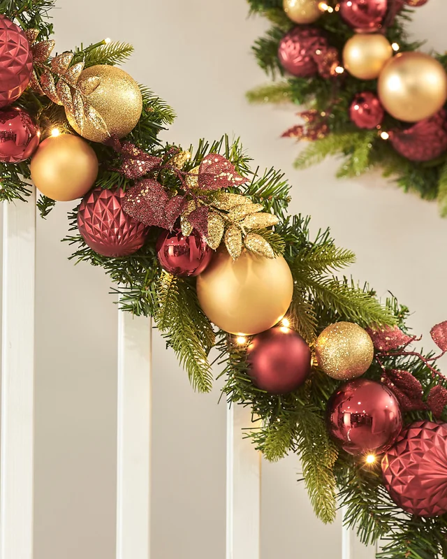 WeRChristmas Multi-Colour Pre-Lit Artificial Christmas Garland With Burgundy And Gold Baubles 100 Warm White Leds 9 Ft