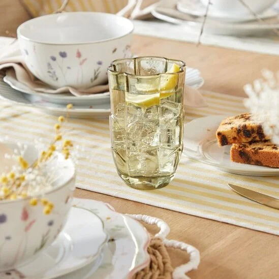 Easter table decor with floral plates, mugs and serveware, as well as Easter themed table runners and place settings.