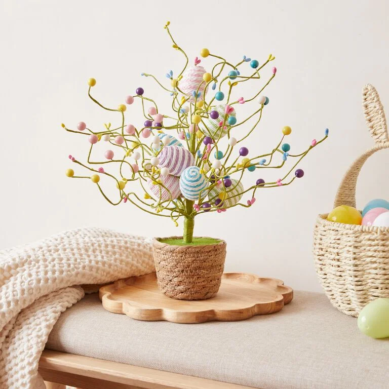 Kitchen decorated with Easter decorations including colourful Egg ornaments, wooden bunny ornaments, an Easter wreath and Easter bunting.