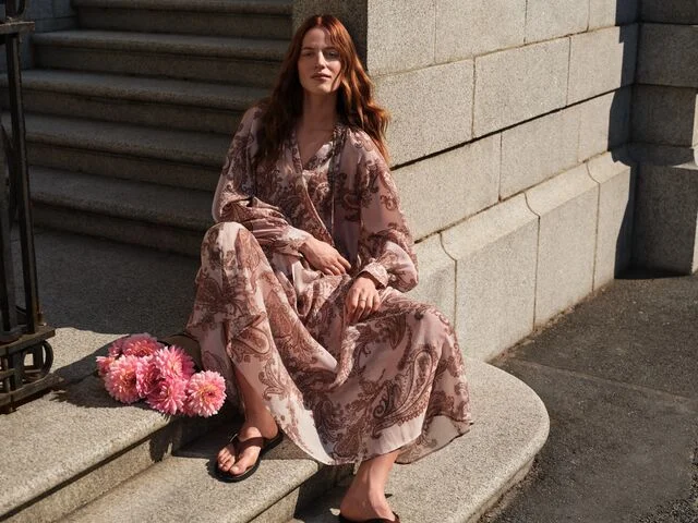 Model wearing a white and pink floral dress