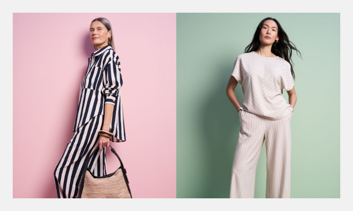 One woman wearing a navy and white striped co ord with a shirt and matching wide leg trousers, holding a beige handbag. Another woman wearing a beige pinstripe co ord with a short sleeved top and wide leg trousers.