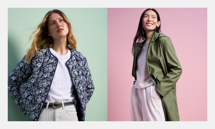 One woman wearing a white t-shirt with a navy quilted floral jacket over the top. Another woman wearing a plain co ord with a khaki rain mac over the top.